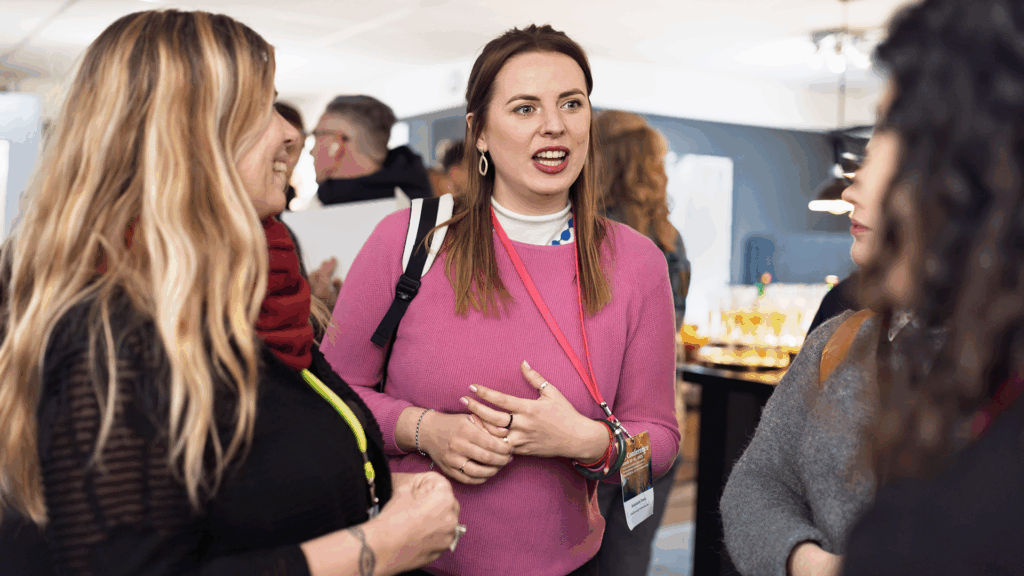 Three people standing and talking.